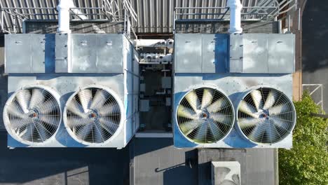 top down aerial of spinning ventilation ac units on rooftop