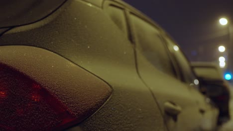 close shot of frost on parked car in street in winter night, riga, latvia