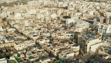 Beige-Brown-Apartment-Blocks-in-Hot-Area-in-Sunlight-on-Malta-Island,-Aerial-Drone-forward-tilt-down-dolly