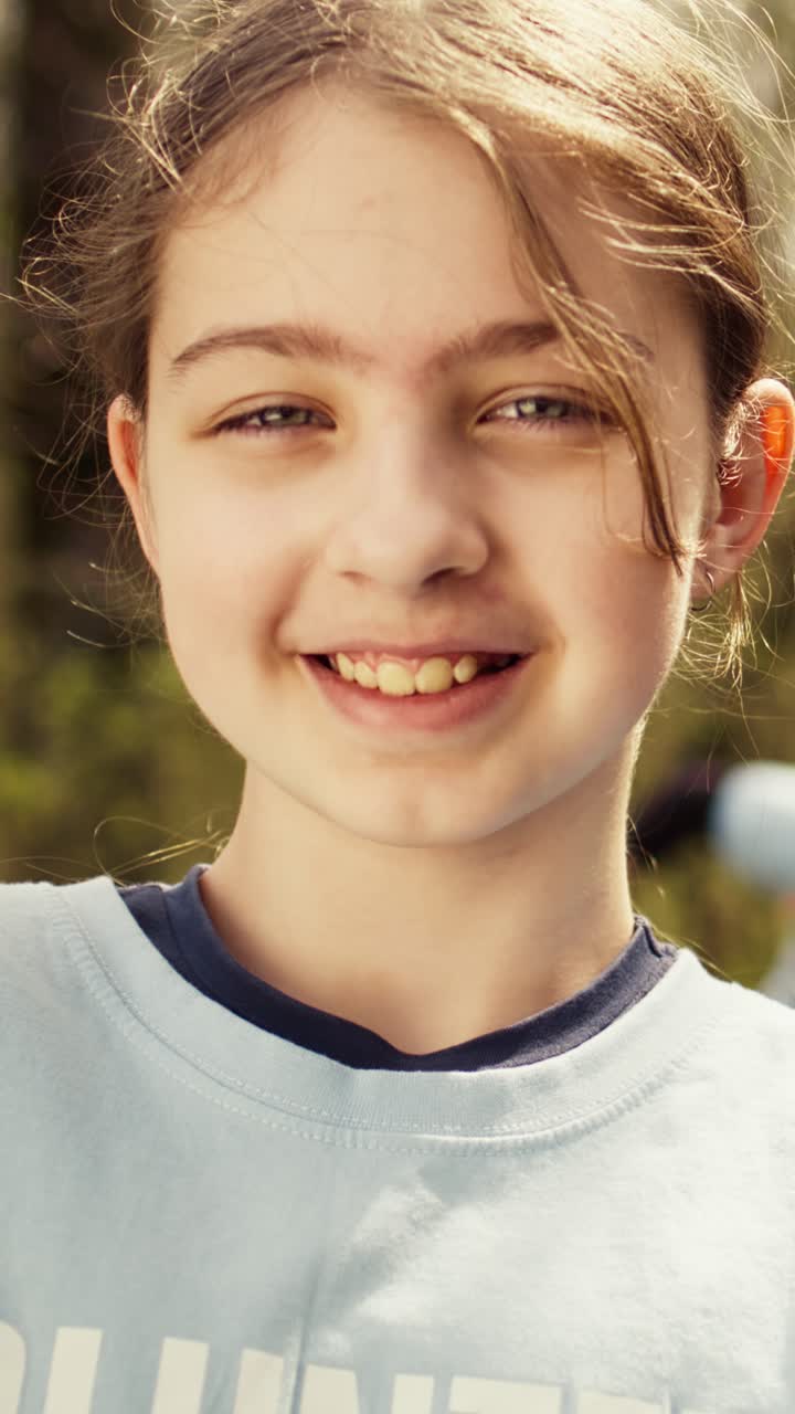 Young Volunteer Holding Small Plant and Smiling