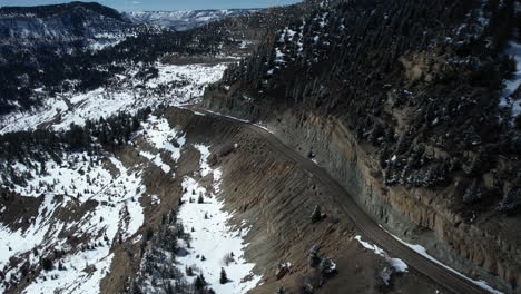 Aerial-View-of-Douglas-Pass,-Colorado-USA,-Road-on-Scenic-Route-on-Sunny-Winter-Day