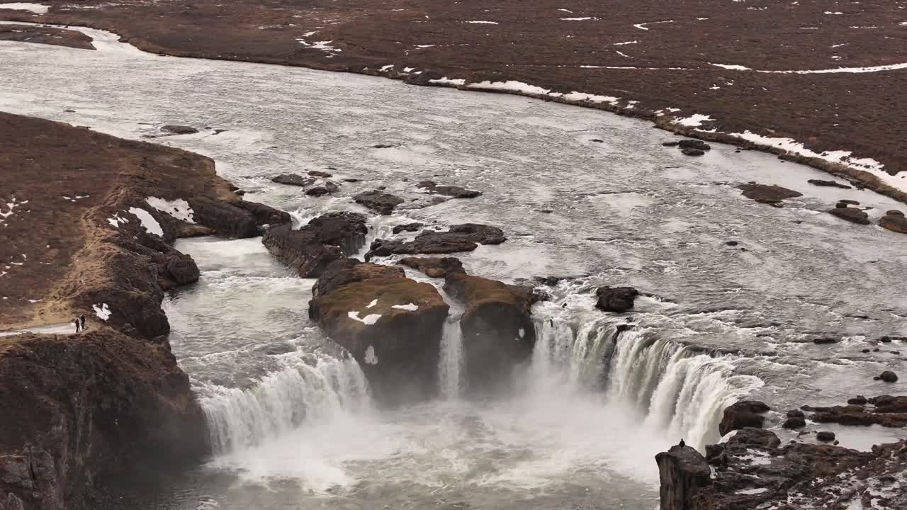 Thundering Goðafoss cascades into a swirling misty pool in northern Iceland