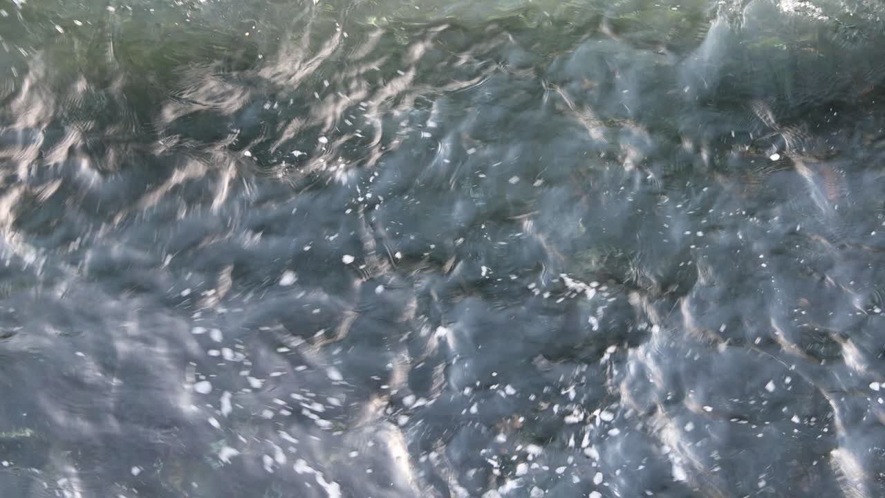 Glistening reflections of water with shadow above and foam, water splash background