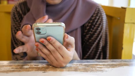 woman using a smartphone in a cafe