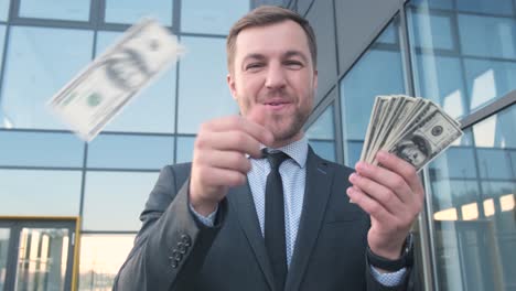 a man holding money and smiling