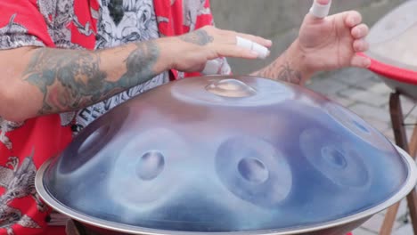 person playing a handpan instrument