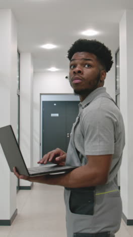 worker using laptop in hallway