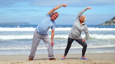 Senior-couple-performing-stretching-exercise