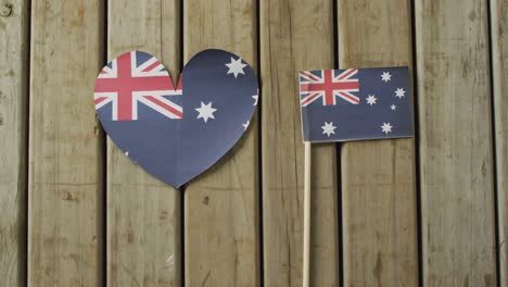 video of flags of australia in shape of heart and rectangle on wooden background