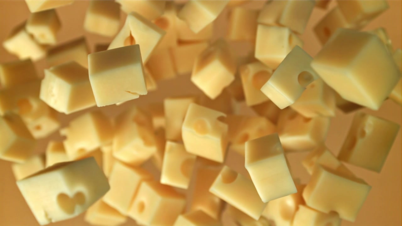Gros plan de cubes de fromage jaune tombant au ralenti