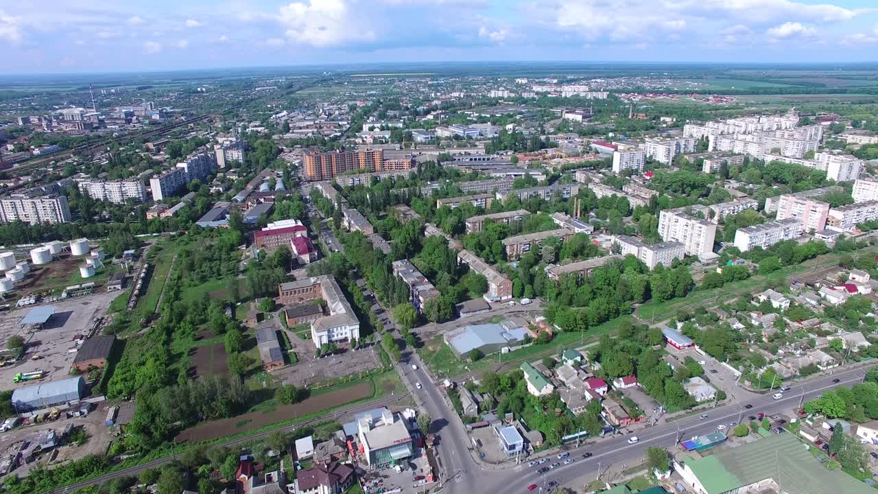 Top View On The Panorama Of City. Aerial shot of the crossroads and roads, houses, buildings, urban landscape