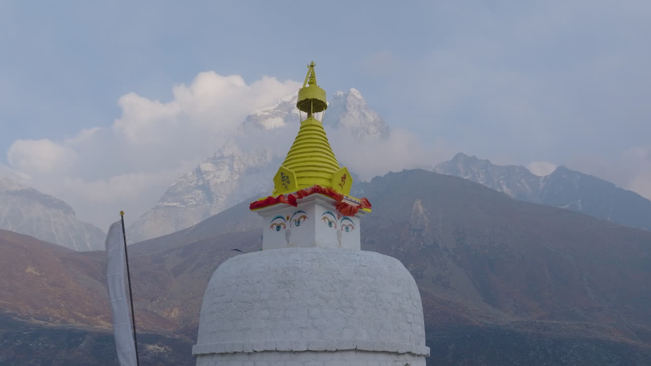 Drone shot of Dingboche’s Buddhist Stupa at 4400m. Serene Himalayas, proud mountains, and Nepalese spiritual unity in Everest Base Camp trek route, stunning view religious significance