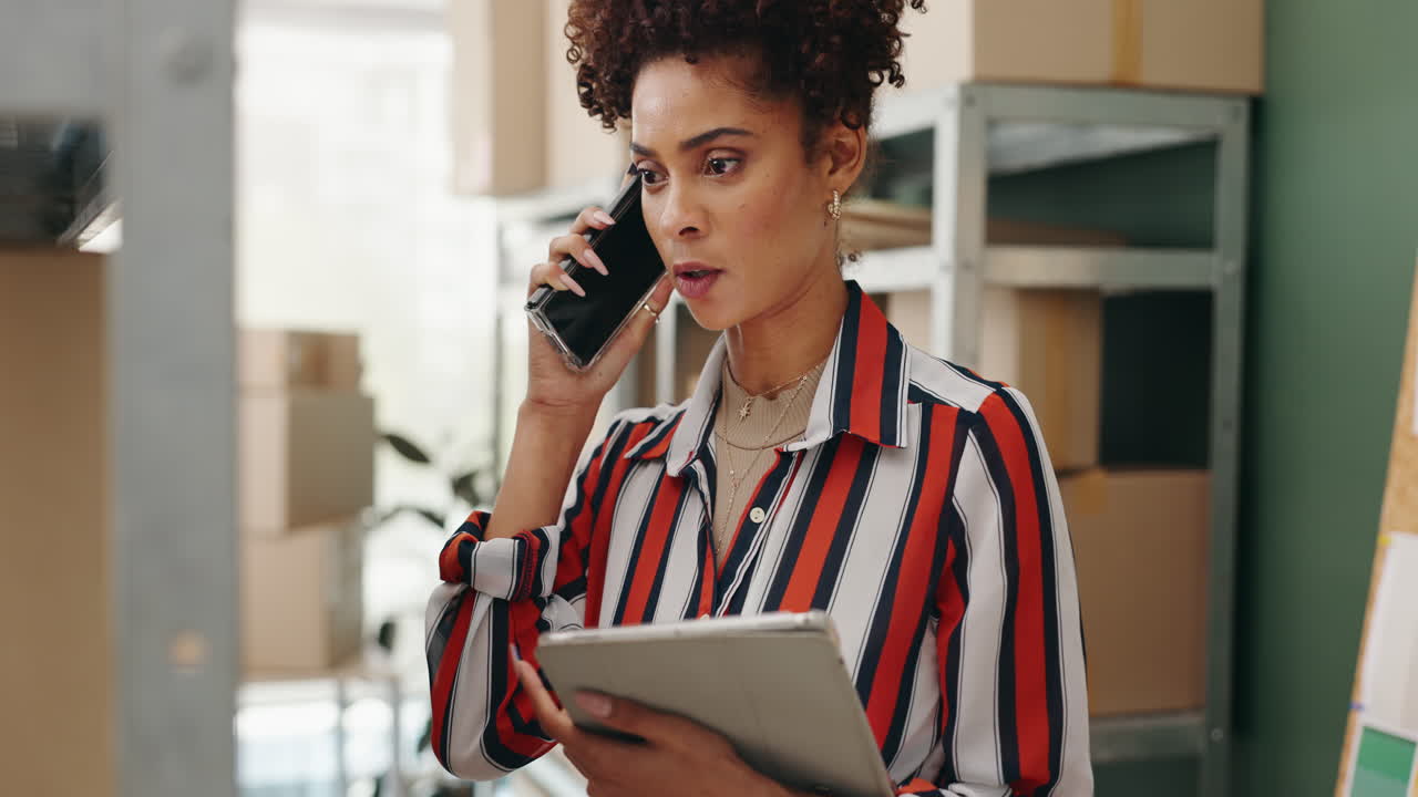 Woman on phone with tablet in warehouse
