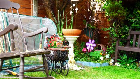 colourful spinning childlike windmills blowing in breeze among variety of flowering plants and flowers