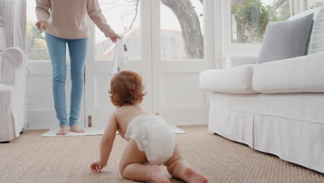 happy mother teaching baby crawling toddler at home with mother helping infant child motherhood responsibility 4k