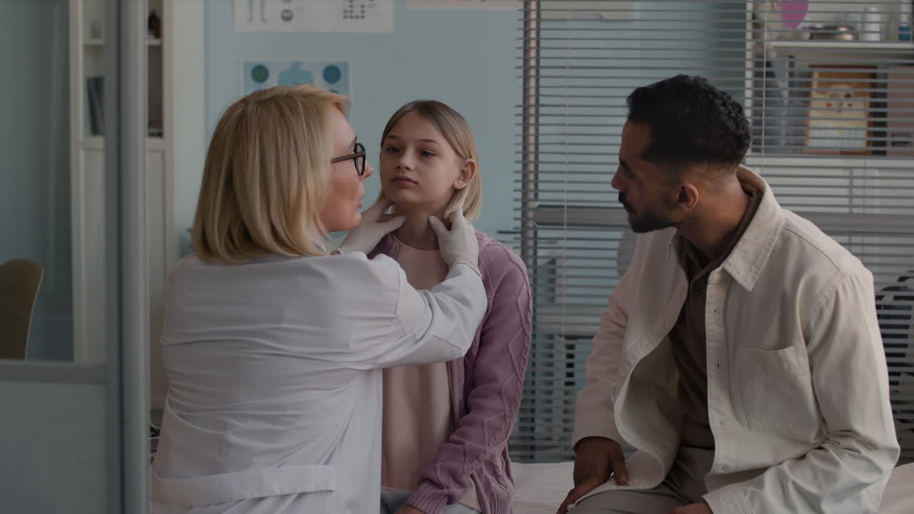 Doctor examining child with father present
