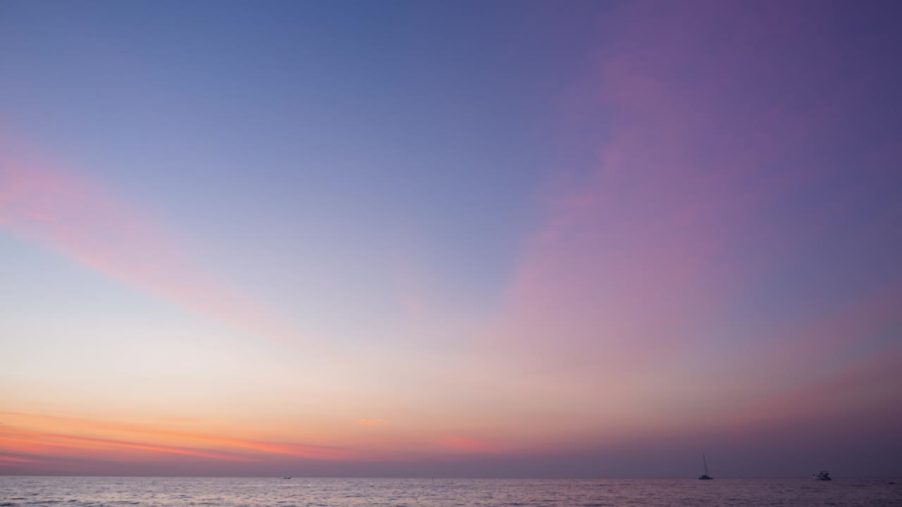 abstract colorful twilight sky. pink pastel panoramic view at seacoast in Thailand. clouds moving slowly in the wide space. romantic color of sunset overseas. nature light footage b-roll timelapse