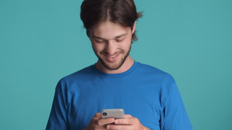 Caucasian-man-in-front-of-camera-on-blue-background.