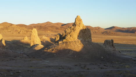 low drone shot between the trona pinnacles during the sunrise