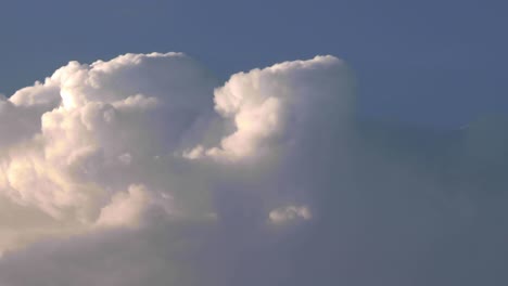 Billowing-clouds,-cumulonembus-growing-a-storm-at-the-sunset