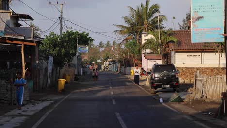 rural street of gerupuk fisher village in lombok, indonesia during daytime - static shot
