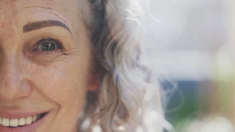 Half-portrait-of-happy-senior-caucasian-woman-smiling,-with-copy-space,-slow-motion