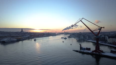 Boats-Cruising-At-Gota-Alv-River-At-Dockland-Area-Of-Lindholmen-With-Double-Jib-Cranes-In-Gothenburg,-Sweden