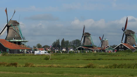 windmills, netherlands: panoramic view of windmills and tourists visit the place