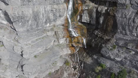 Close-to-wide-aerial-view-of-Bridal-Veil-Falls-in-American-Fork-Canyon,-Utah-during-spring