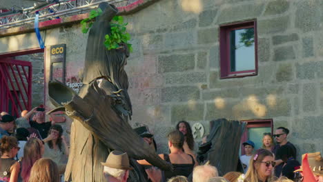 street performer in tree costume at eco museum festival