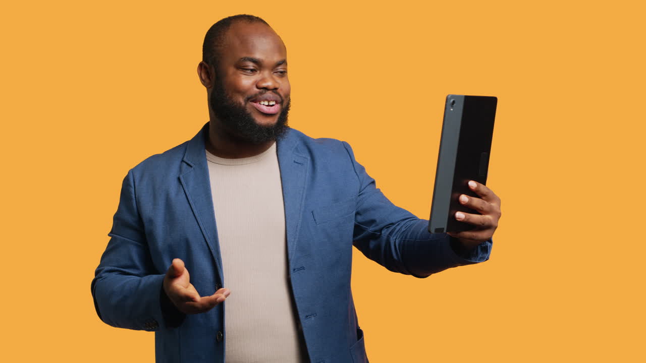 Joyful man having entertaining conversation with friends in videocall