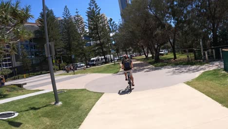 cyclist rides through vibrant urban park