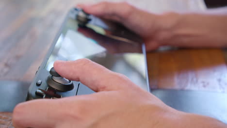 close up playing a video game on a steam deck handheld game system