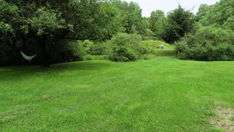 a low creepy drone flight dolly sideways ends on an empty hammock