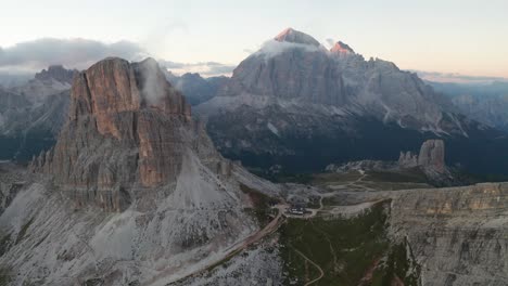 Aerial-wide-shot-of-Averau-Peak-and-hiker-path-during-sunset-at-Cinque-Torri,-Dolomites