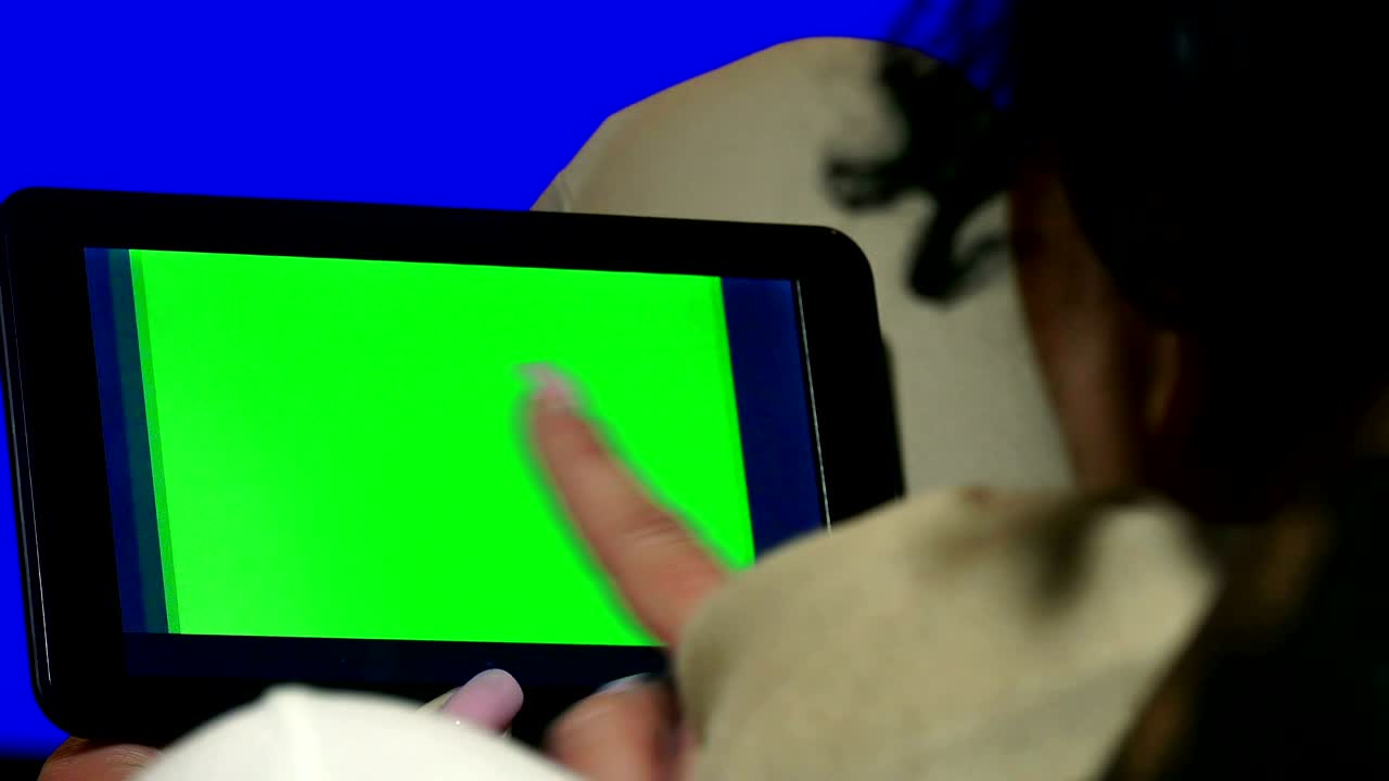 Girl Using Tablet PC with Green Screen. 4K UHD stock video, alpha luma matte included