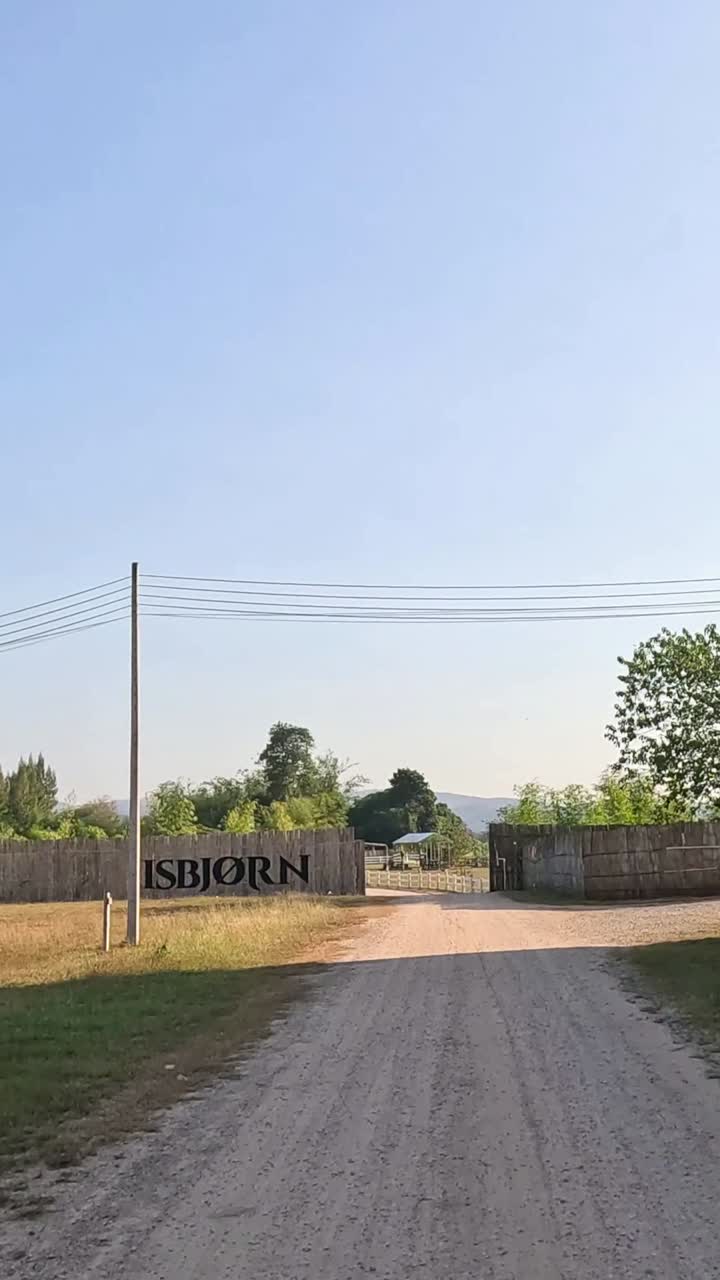 Advancing view of a rural road and buildings