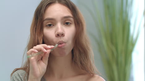 beautiful woman brushing teeth