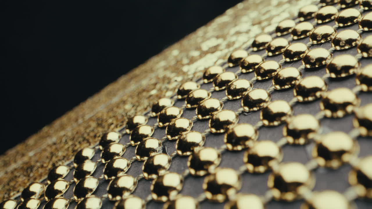 Close-up of Gold Studs on a Fabric Surface