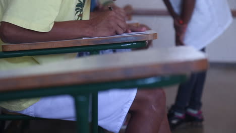 man writing a letter sitting on a chair