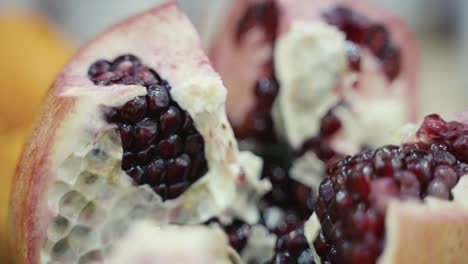 Macro-slider-shot-of-a-pomegranate-that-has-been-opened-to-reveal-the-seeds-inside