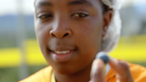female worker showing blueberry in hand 4k