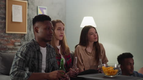 Black-man-drinks-bottle-beer-with-girlfriend-and-roommates