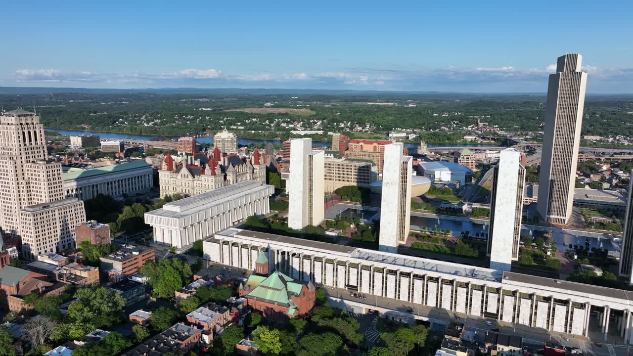 New York State capitol, Hudson River, Empire State plaza with office buildings during golden sunset in Albany, New York. Aerial wide shot. Peaceful downtown scene in summer