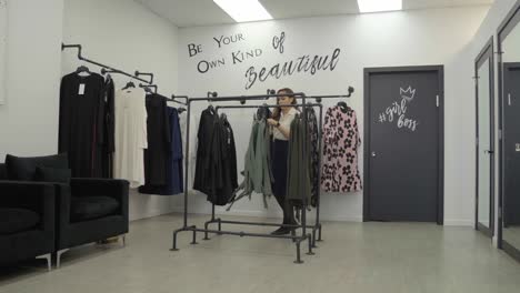 woman shopping for dresses in a store