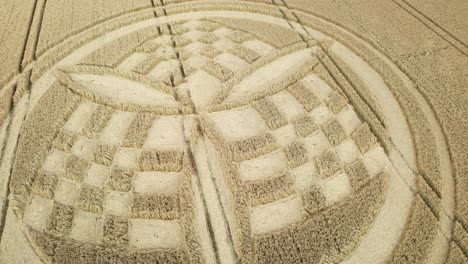 Low-aerial-view-circling-South-Wonston-2023-propeller-chequered-crop-circle-on-golden-Hampshire-wheat-field