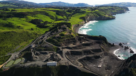 Coastal-Blackhead-quarry-in-New-Zealand-landscape,-aerial-drone-view