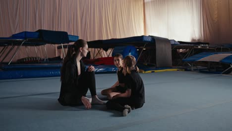 young gymnast training with her coach in the gym