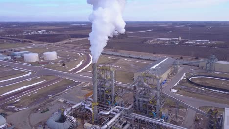 an aerial shot over an oil refinery spewing pollution into the air 2