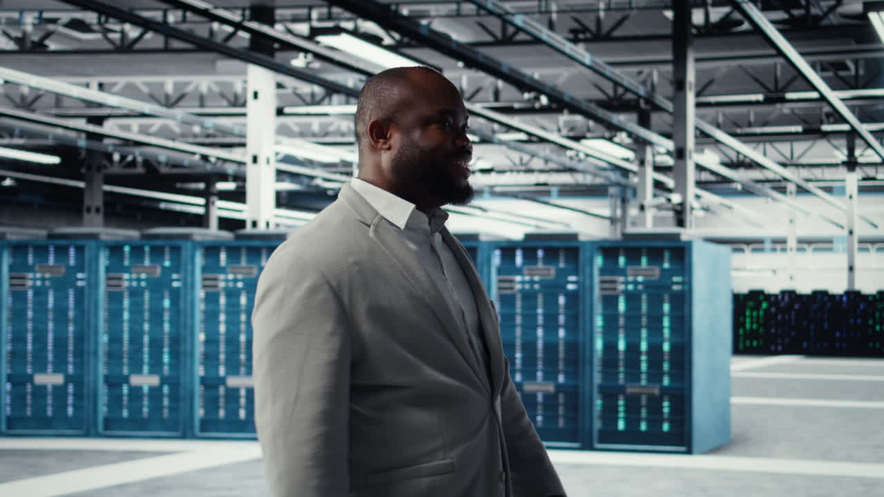 Vertical video Happy businessman walking in data center, assessing capacity before investing
